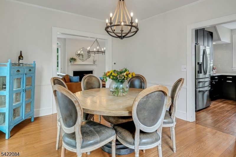 122 Kenilworth Road Mountain Lakes, NJ 07046 - Photo 21 of 45 a view of a dining room with furniture a chandelier and wooden floor