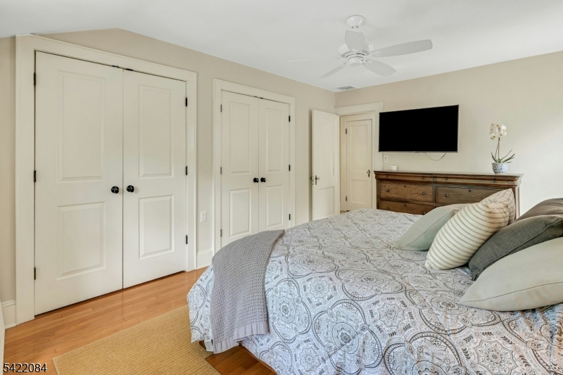 122 Kenilworth Road Mountain Lakes, NJ 07046 - Photo 33 of 45 a bedroom with a bed and a flat screen tv