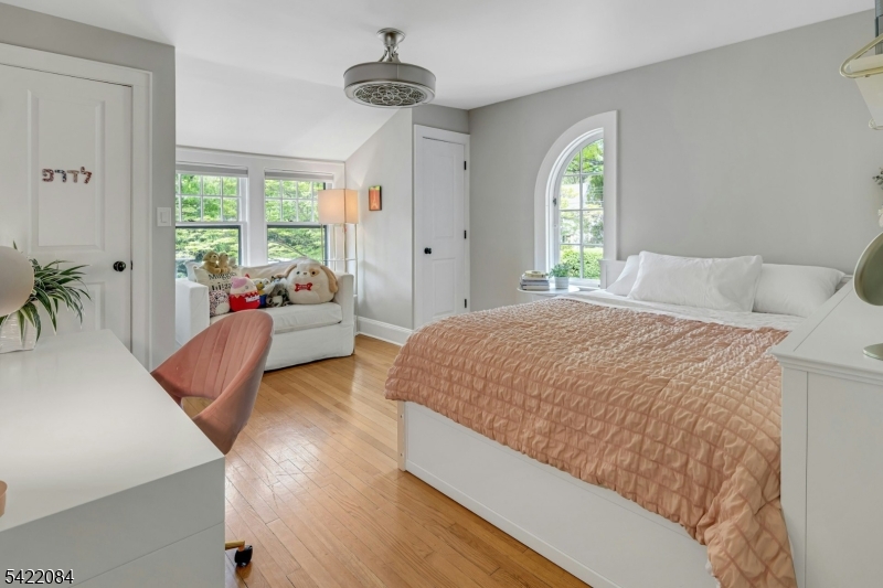 122 Kenilworth Road Mountain Lakes, NJ 07046 - Photo 34 of 45 a spacious bedroom with a bed and a couch