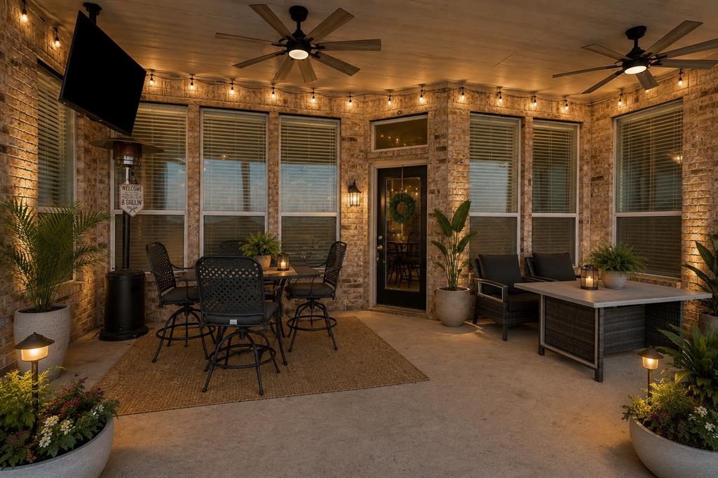 205 King George Road Ponder, TX 76259 - Photo 27 of 37 Covered patio with brick exterior, multiple ceiling fans, recessed lighting, and a glass-paneled door
