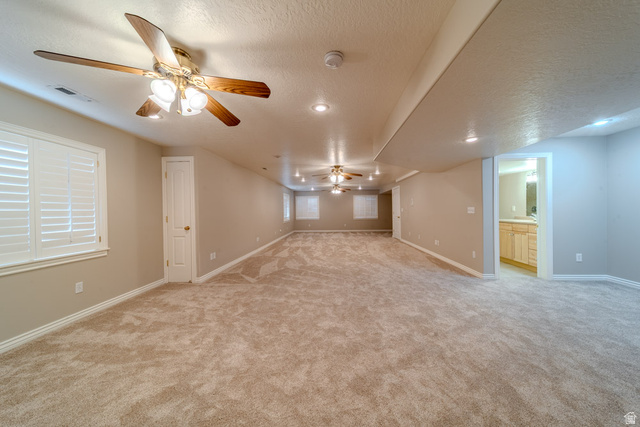598 Hollow Creek Road Draper, UT 84020 - Photo 47 of 110 Expansive carpeted room featuring multiple ceiling fans with integrated lighting, recessed lighting, and white plantation shutters
