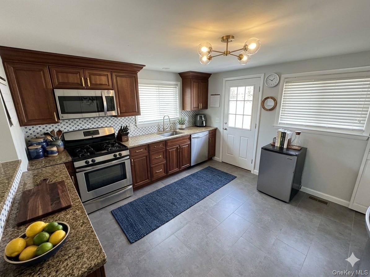 20 Walker Road Highland Falls, NY 10928 - Photo 8 of 10 Kitchen featuring stainless steel appliances, tasteful backsplash, and light tile patterned flooring