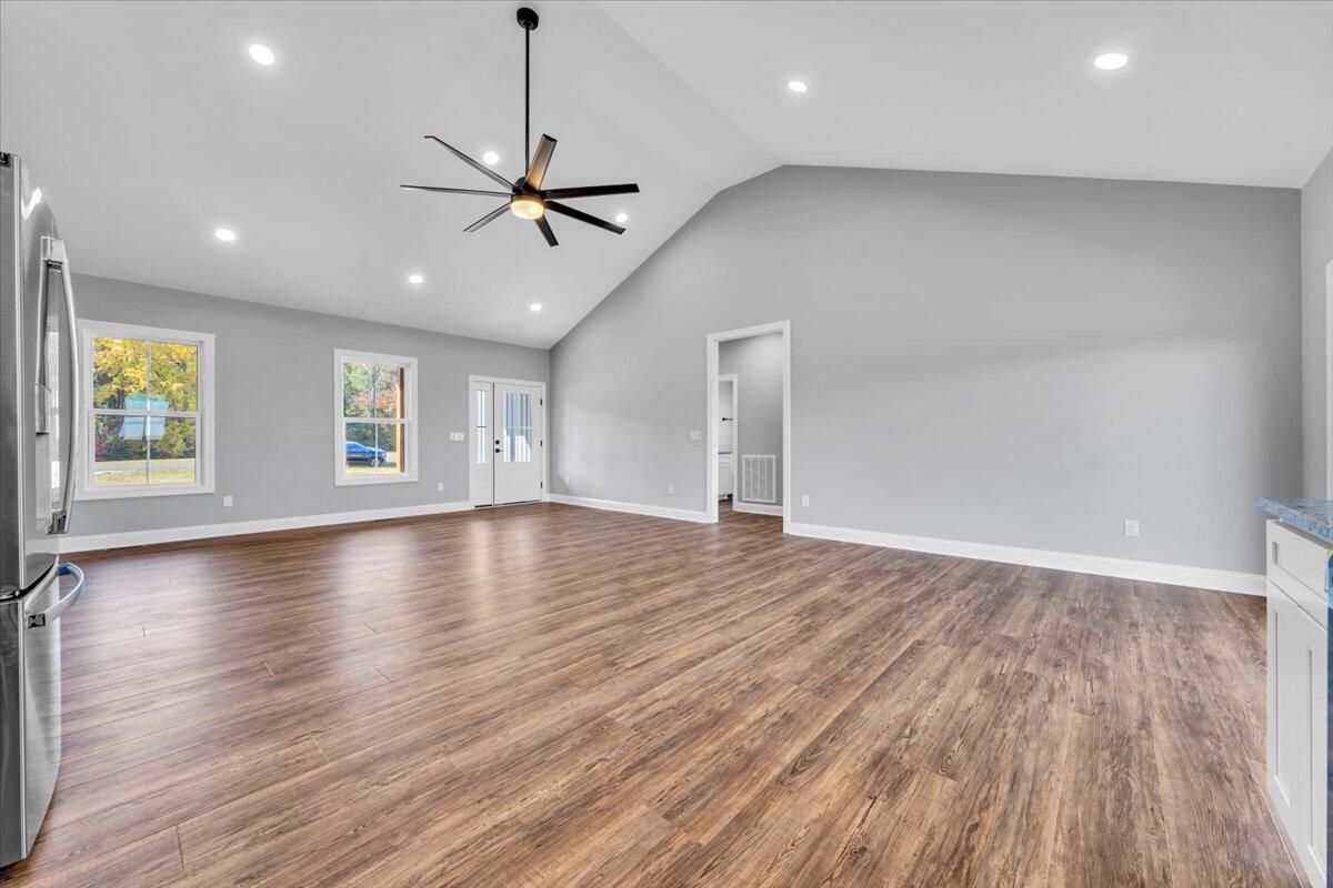 224 Marshall Mill Road Gladys, VA 24554 - Photo 13 of 38 an empty room with window wooden floor and a ceiling fan