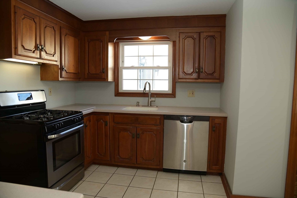 15 Highfield Road Boston, MA 02131 - Photo 15 of 41 a kitchen with stainless steel appliances granite countertop a stove a sink and a microwave
