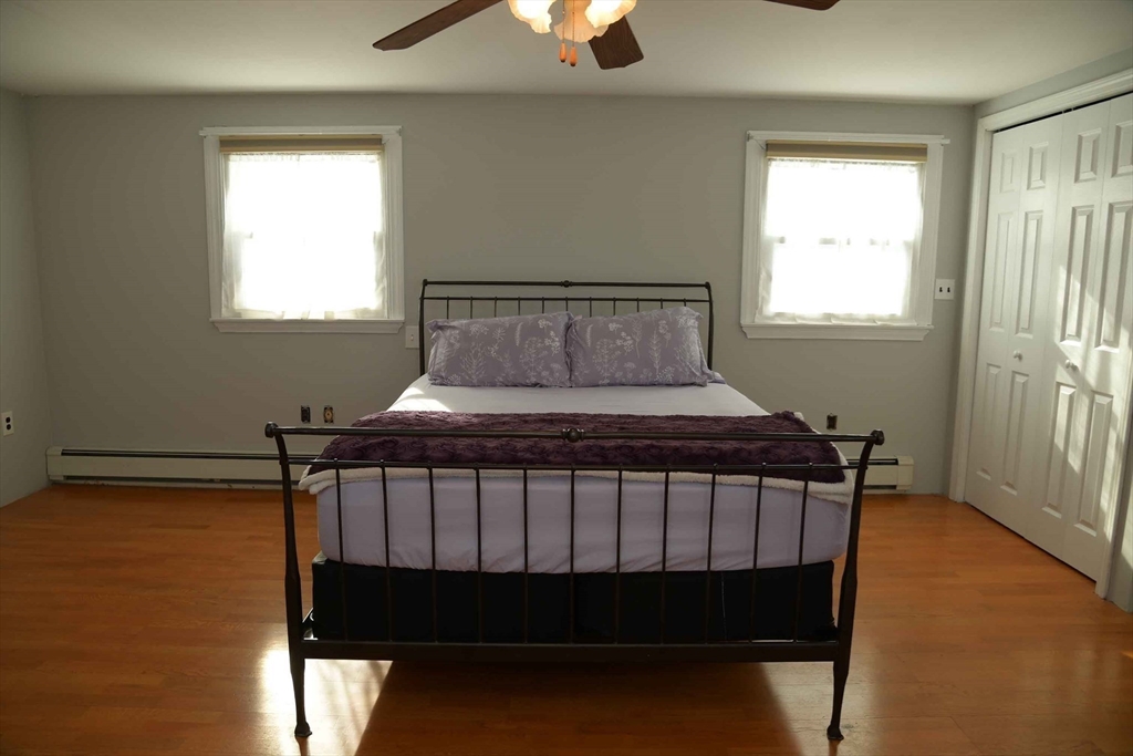 15 Highfield Road Boston, MA 02131 - Photo 24 of 41 a bedroom with a bed window and a chandelier