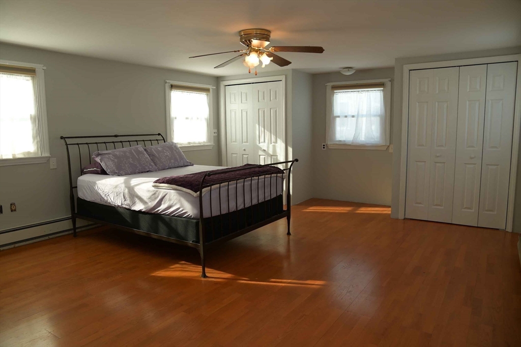 15 Highfield Road Boston, MA 02131 - Photo 26 of 41 a bed sitting in a bedroom next to a window and a chandelier