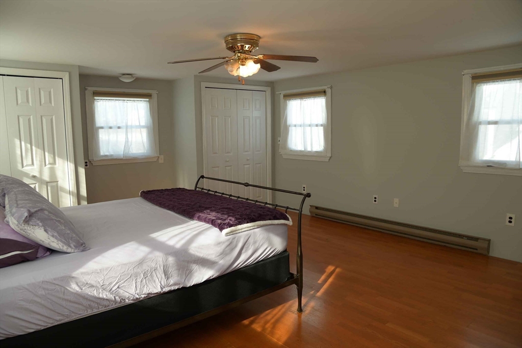 15 Highfield Road Boston, MA 02131 - Photo 27 of 41 a bed sitting in a bedroom next to a window