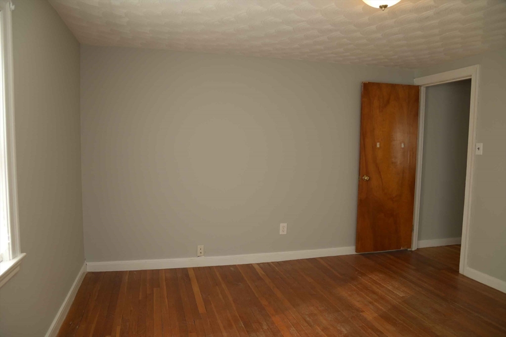 15 Highfield Road Boston, MA 02131 - Photo 28 of 41 a view of an empty room with wooden floor and a window