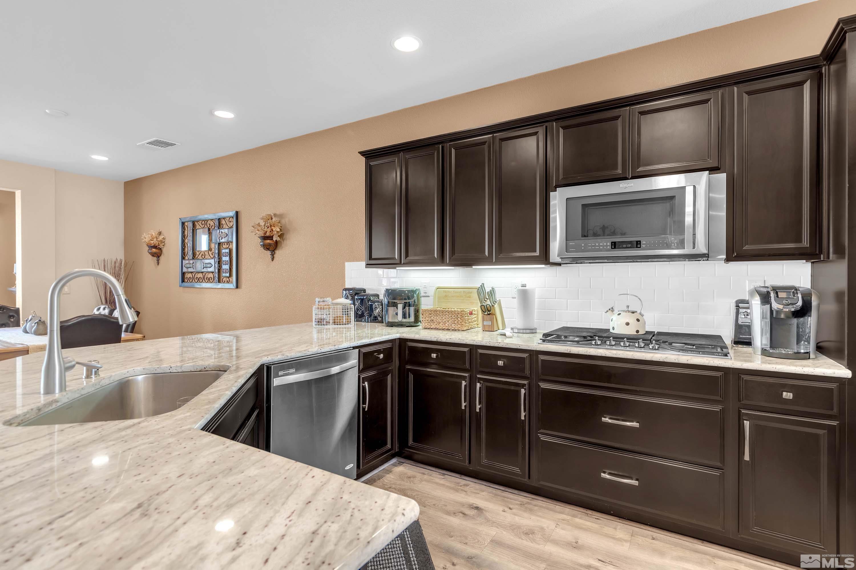 895 Larrimore Trail Reno, NV 89523 - Photo 11 of 39 a kitchen with granite countertop a sink and cabinets