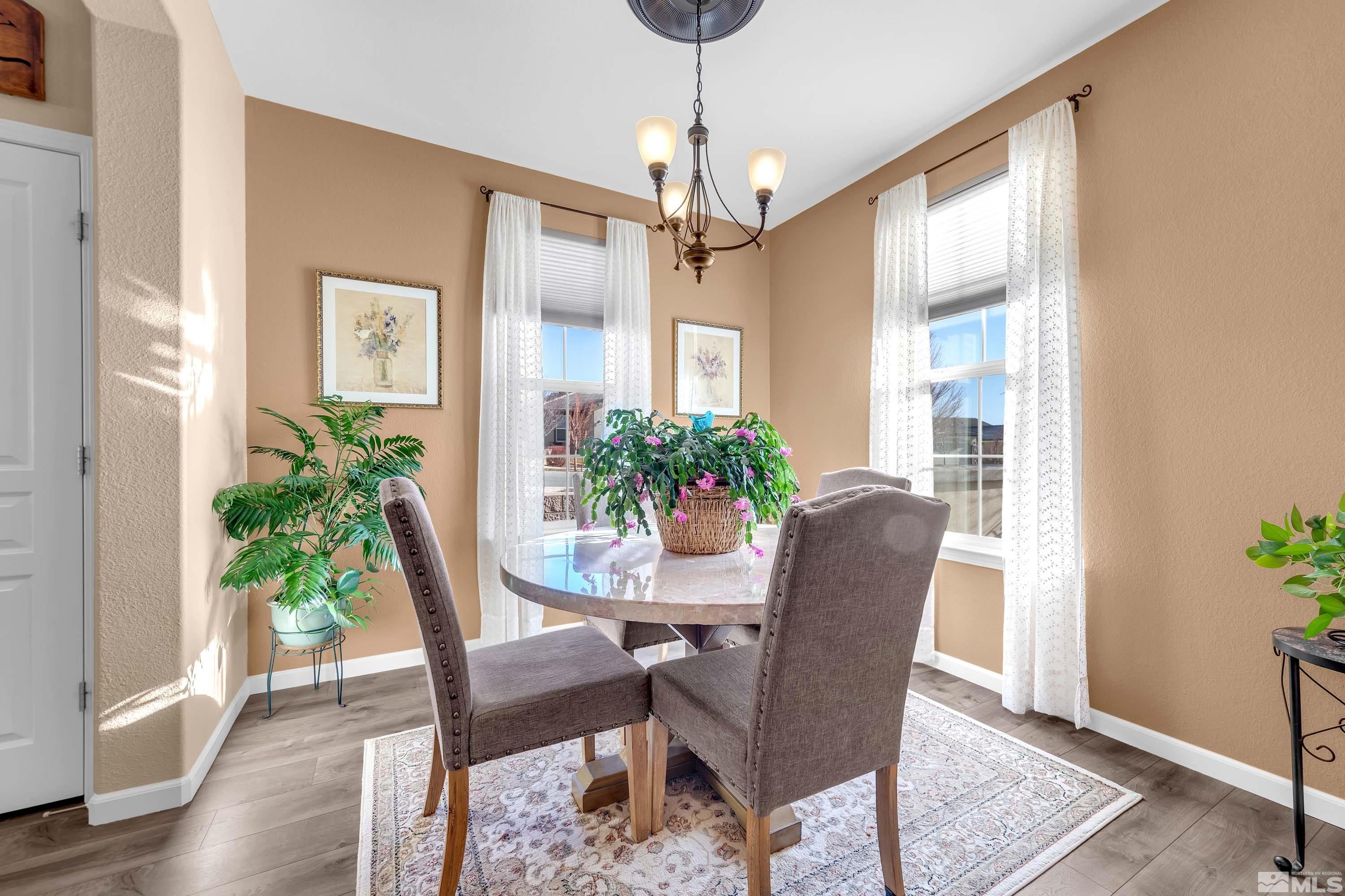 895 Larrimore Trail Reno, NV 89523 - Photo 13 of 39 a dining room with furniture potted plants and wooden floor