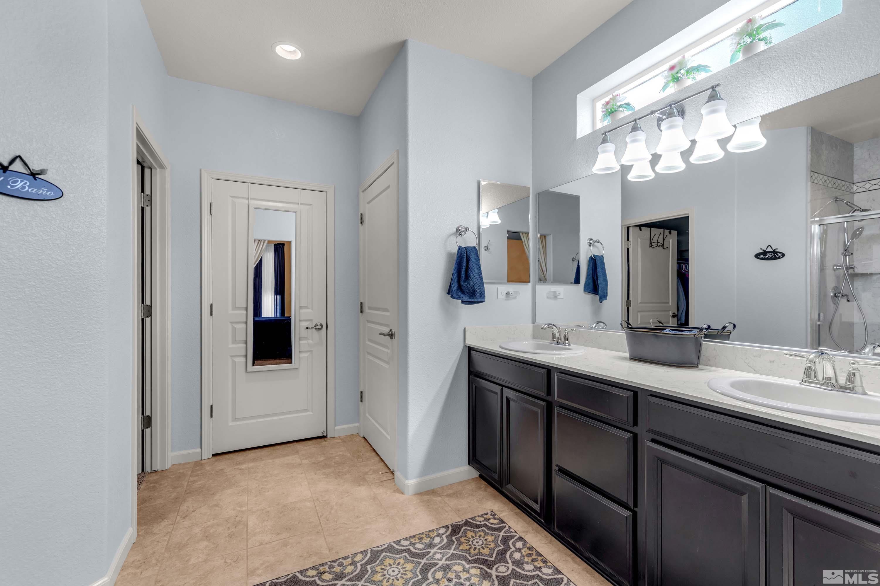 895 Larrimore Trail Reno, NV 89523 - Photo 28 of 39 a spacious bathroom with a double vanity sink and a mirror