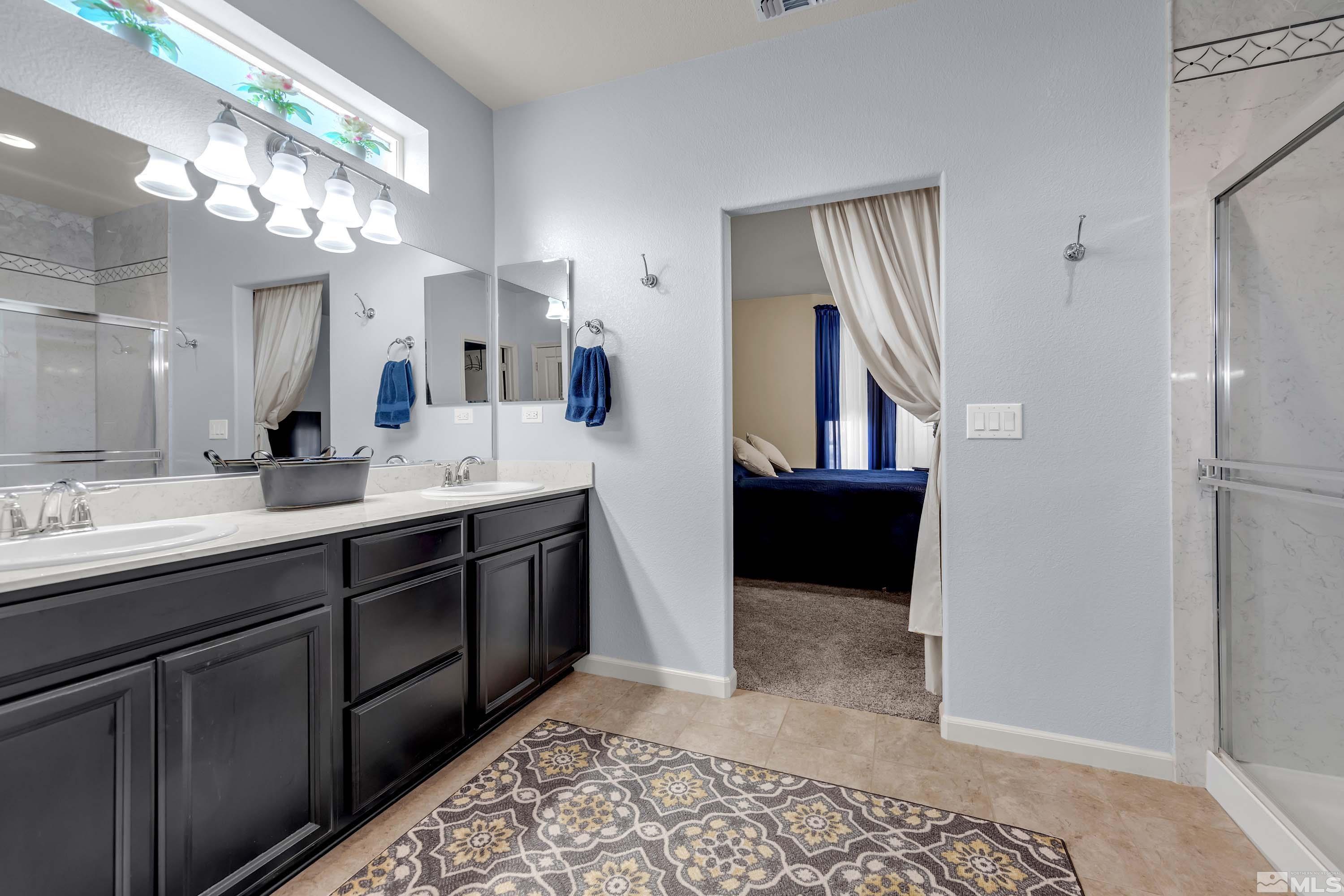 895 Larrimore Trail Reno, NV 89523 - Photo 30 of 39 a bathroom with a double vanity sink and a mirror