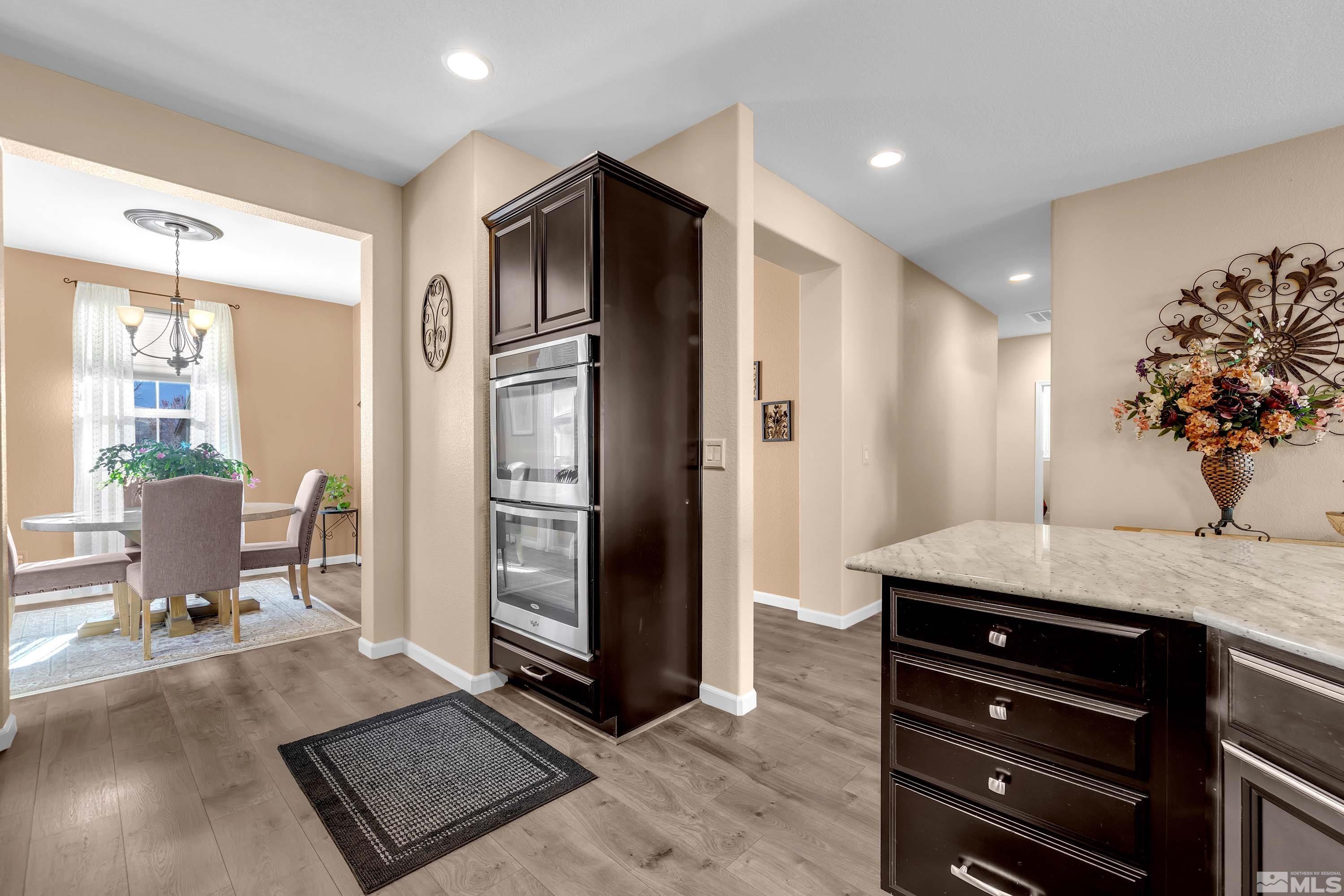 895 Larrimore Trail Reno, NV 89523 - Photo 10 of 39 a kitchen with granite countertop a refrigerator and a sink