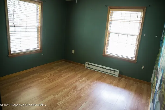 a view of wooden floor and windows in a room