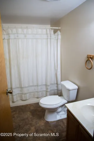 a bathroom with a toilet a sink and a shower