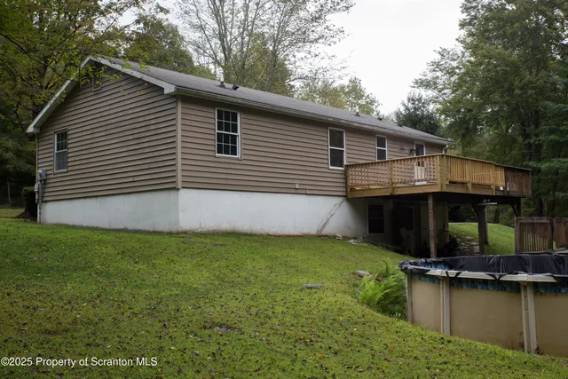 a backyard of a house with yard table and chairs