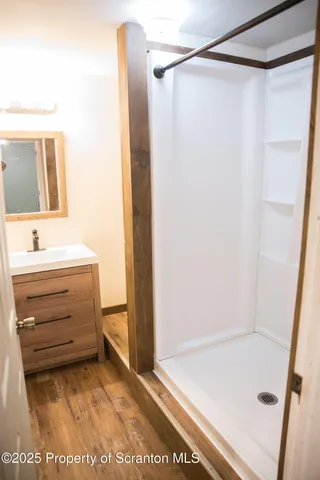 a bathroom with a shower and a sink