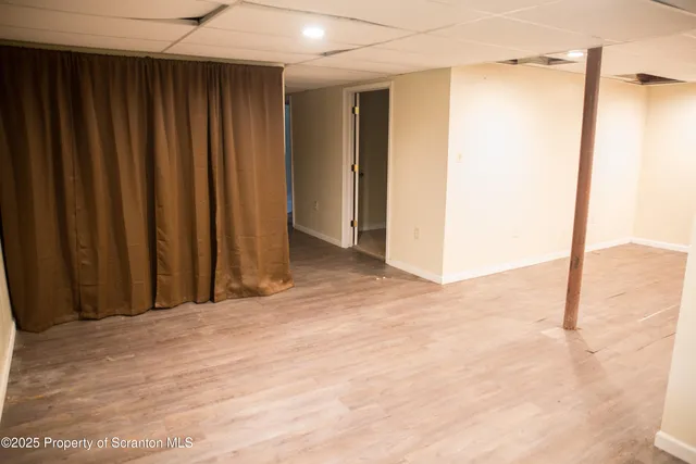 a view of a room with a wooden door