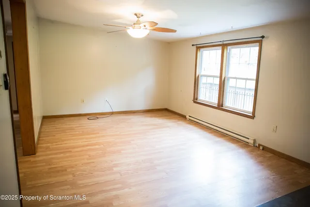 wooden floor in an empty room with a window