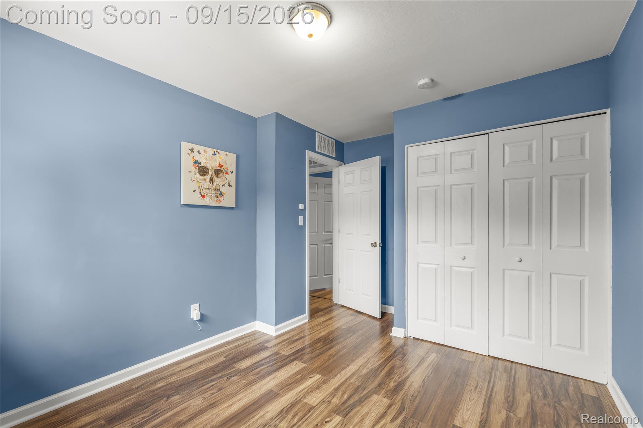 22947 Tuck Road Farmington, MI 48336 - Photo 17 of 34 Wood-finish flooring, bi-fold closet doors, ceiling-mounted light fixture, and panel doors