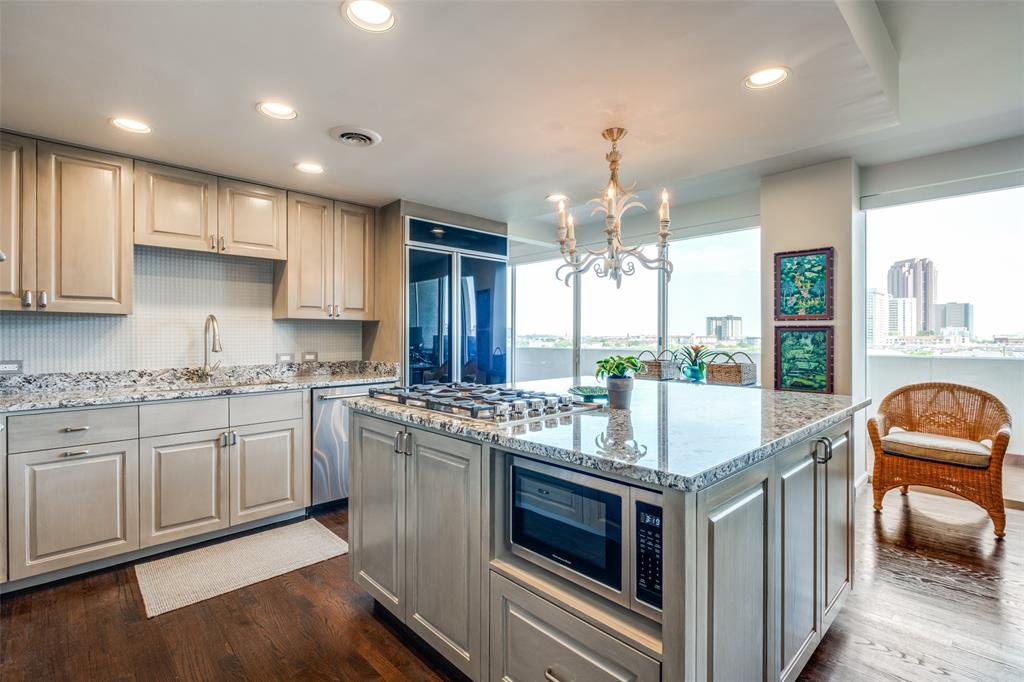 3601 Turtle Creek Boulevard, Unit 1006 Dallas, TX 75219 - Photo 11 of 28 a kitchen with stainless steel appliances granite countertop a stove and a sink