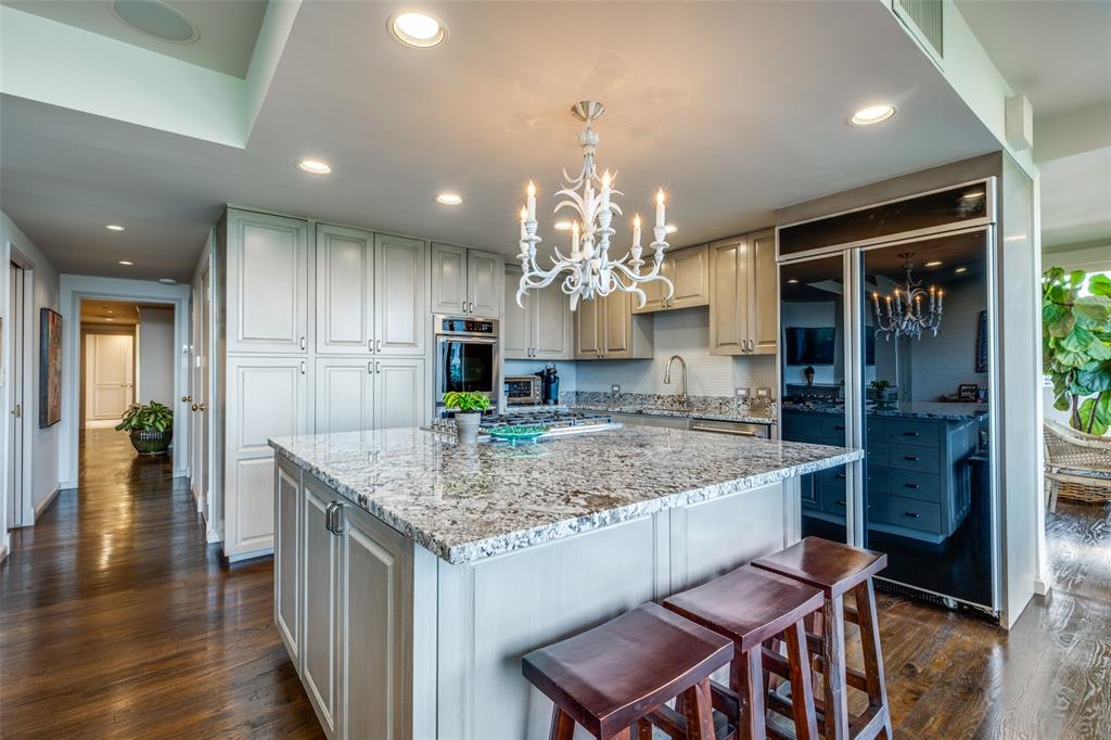 3601 Turtle Creek Boulevard, Unit 1006 Dallas, TX 75219 - Photo 12 of 28 a kitchen with a table and chairs in it