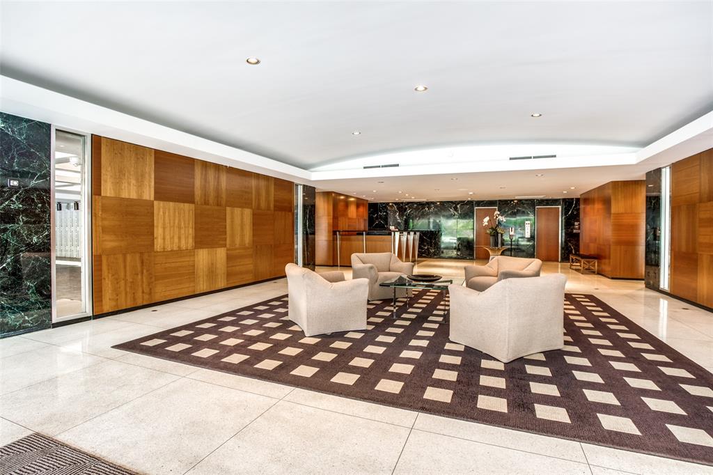 3601 Turtle Creek Boulevard, Unit 1006 Dallas, TX 75219 - Photo 26 of 28 a living room with a table and a potted plant