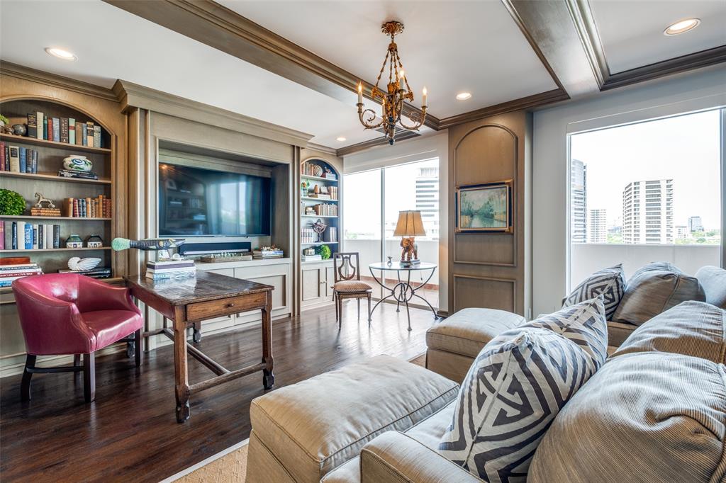 3601 Turtle Creek Boulevard, Unit 1006 Dallas, TX 75219 - Photo 8 of 28 a living room with furniture a chandelier and a flat screen tv