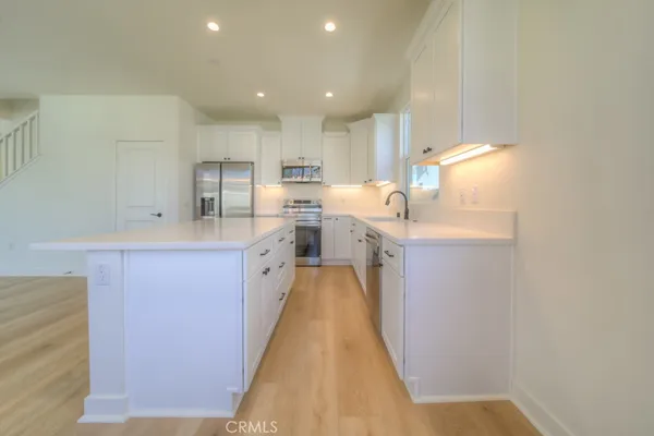 a kitchen with stainless steel appliances granite countertop a sink and cabinets