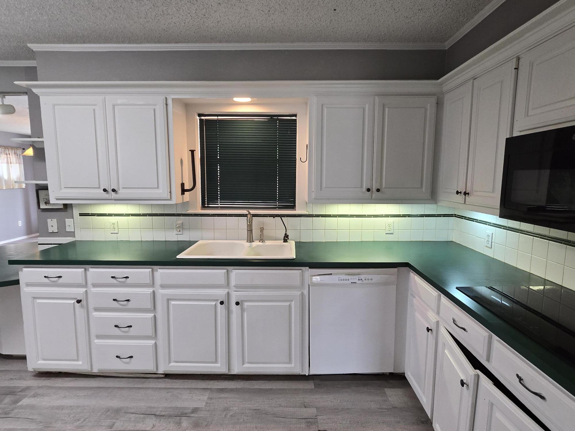 506 North 19th Street Lamesa, TX 79331 - Photo 7 of 29 a kitchen with granite countertop white cabinets and stainless steel appliances