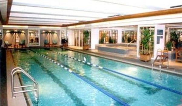 a swimming pool with outdoor seating and yard