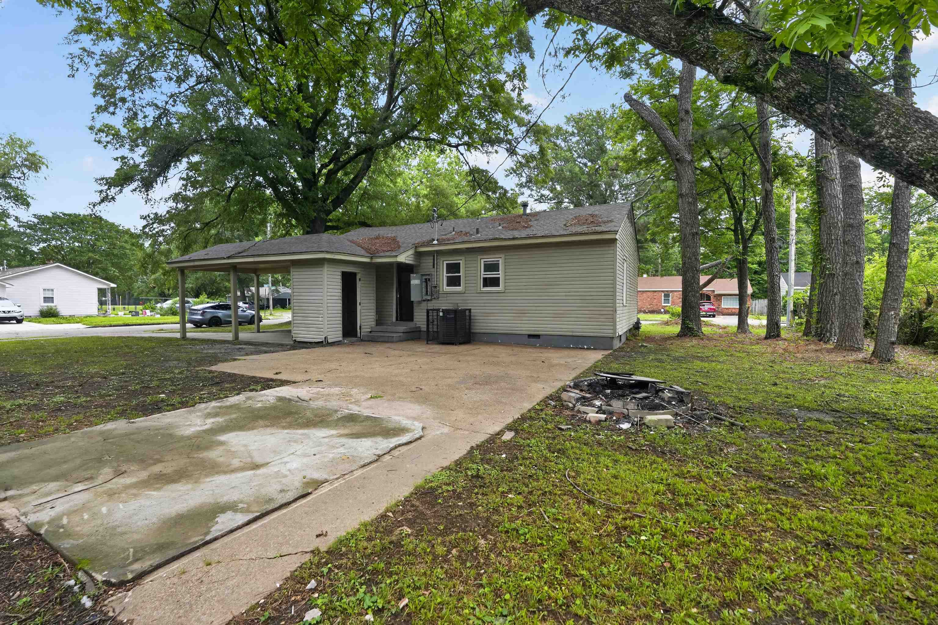 949 Sumter Street Memphis, TN 38122 - Photo 8 of 33 Rear exterior featuring a carport, light green siding, and a concrete driveway