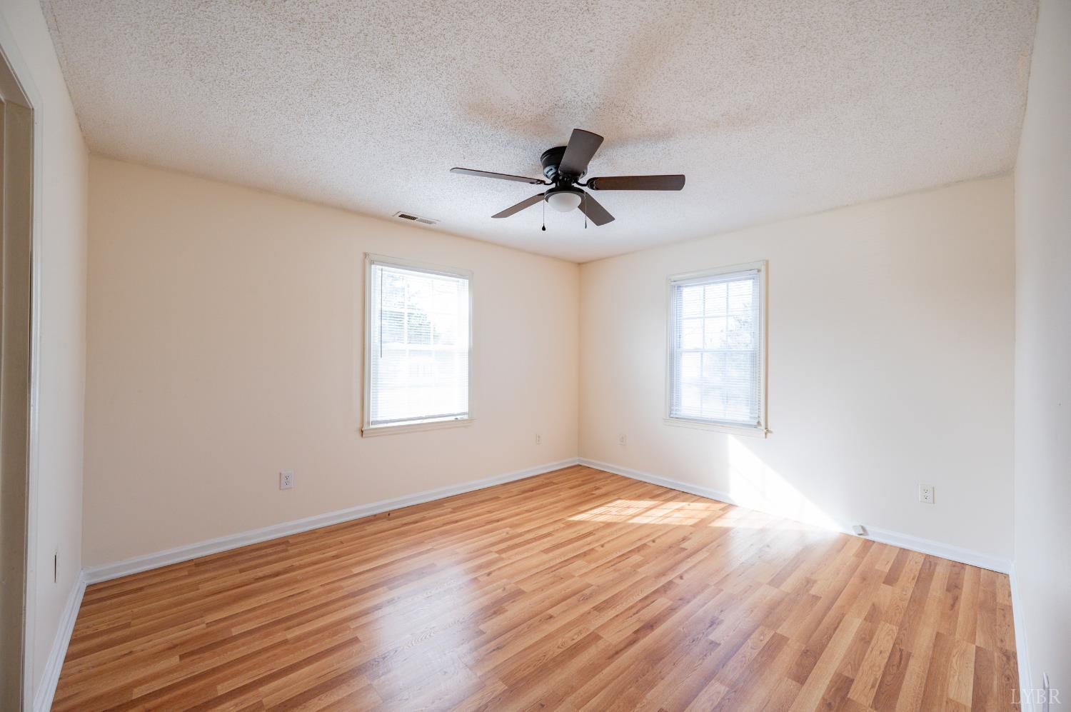 1114 Golden Leaf Road Nathalie, VA 24577 - Photo 15 of 32 a view of empty room with wooden floor and fan