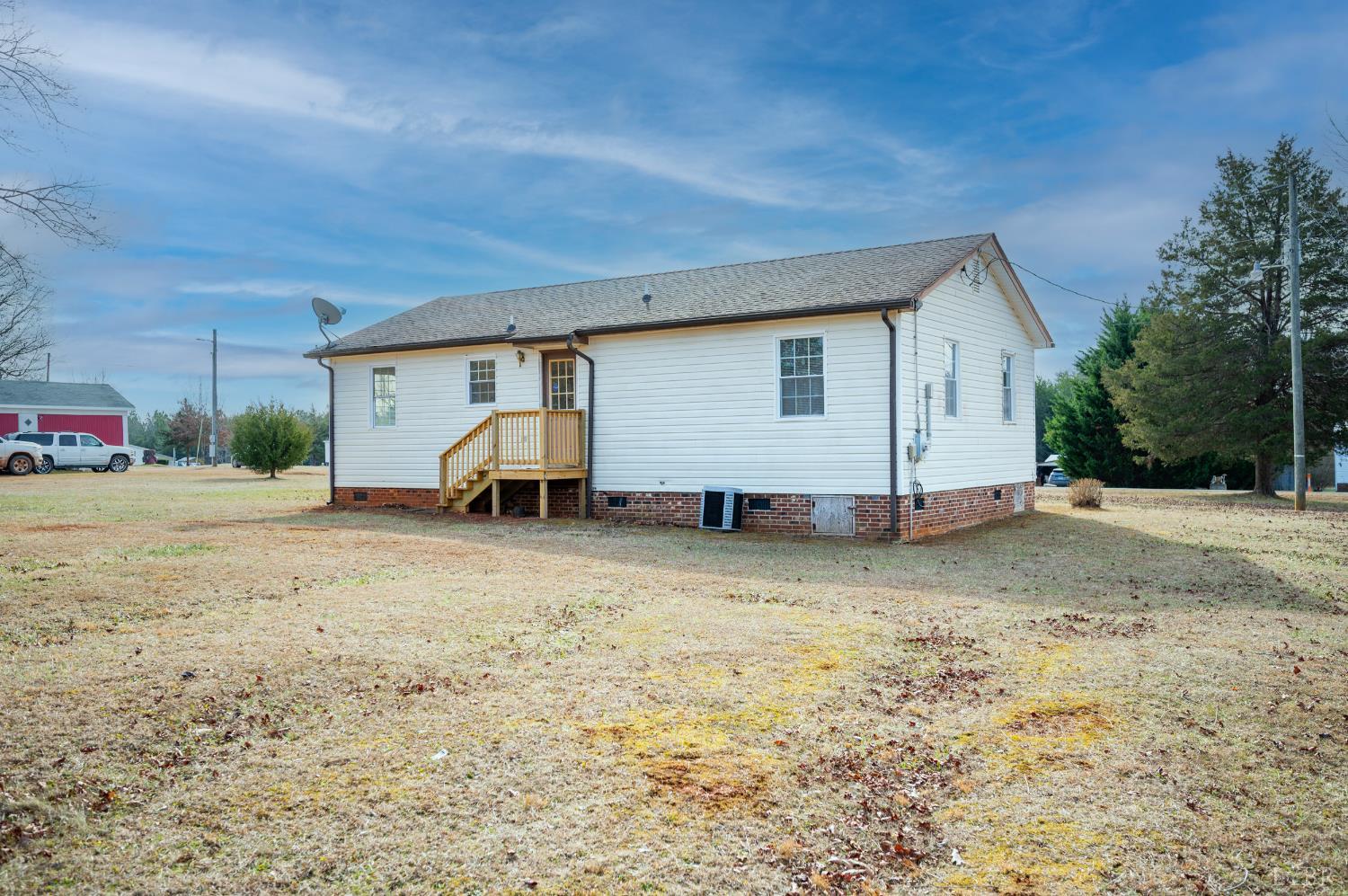 1114 Golden Leaf Road Nathalie, VA 24577 - Photo 27 of 32 a view of a backyard with large trees
