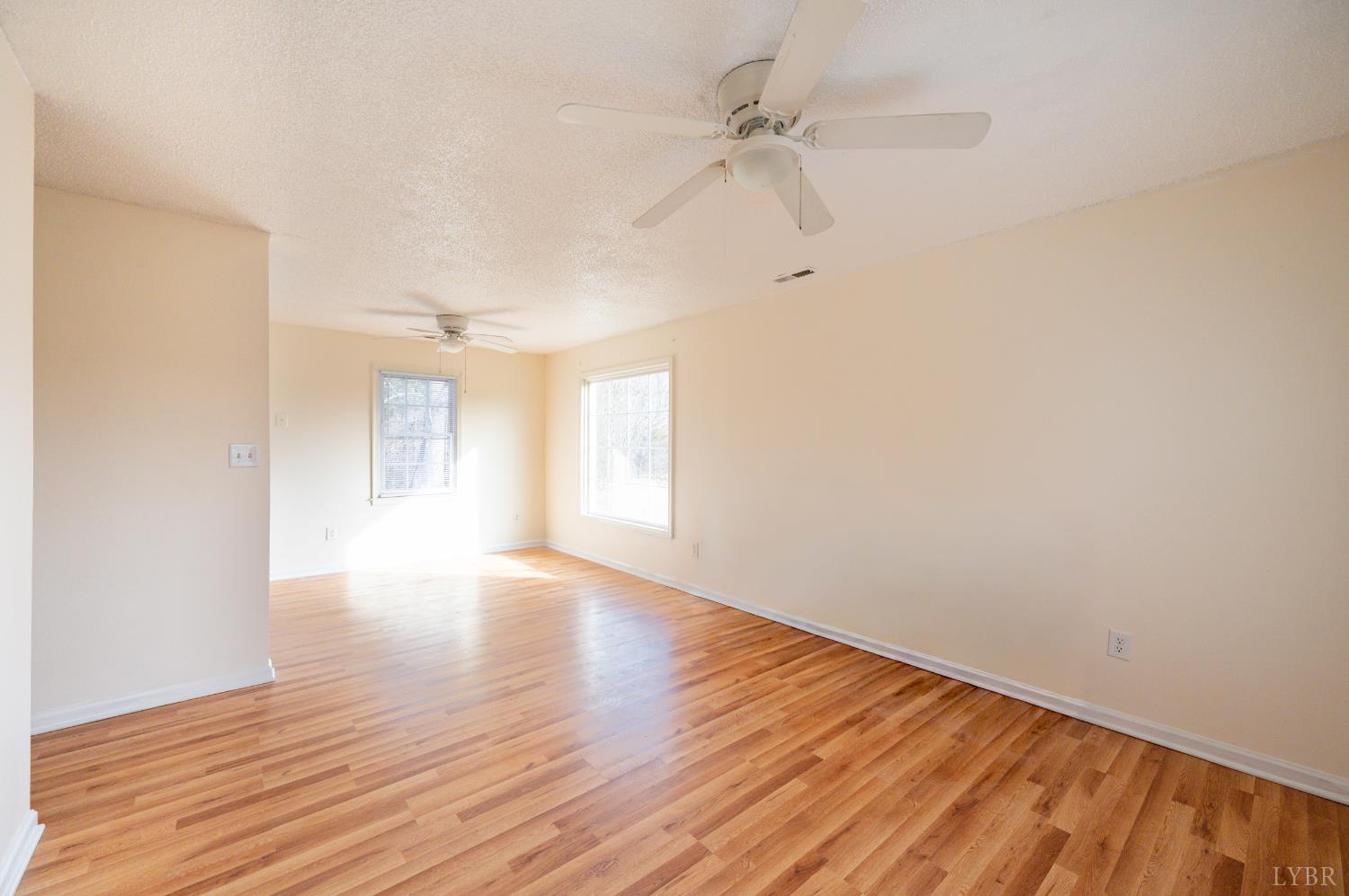 1114 Golden Leaf Road Nathalie, VA 24577 - Photo 6 of 32 a view of an empty room with wooden floor and a window