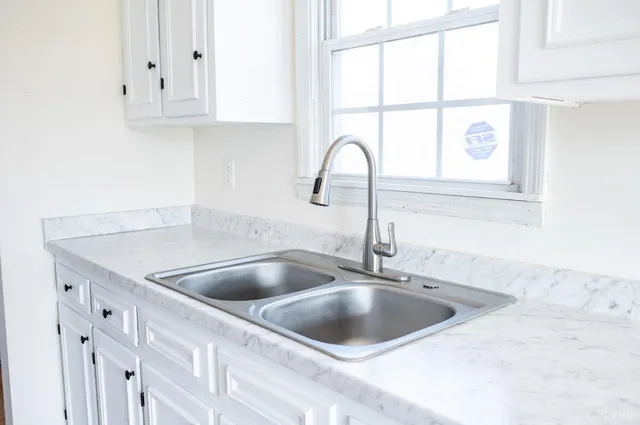 a kitchen with a sink and cabinets