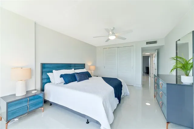 a bedroom with a bed and a potted plant