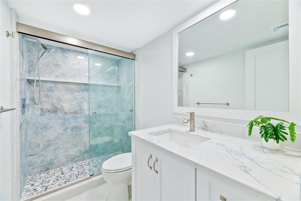 1021 Hillsboro Mile, Unit 308 Hillsboro Beach, FL 33062 - Photo 16 of 24 a bathroom with a sink and a mirror