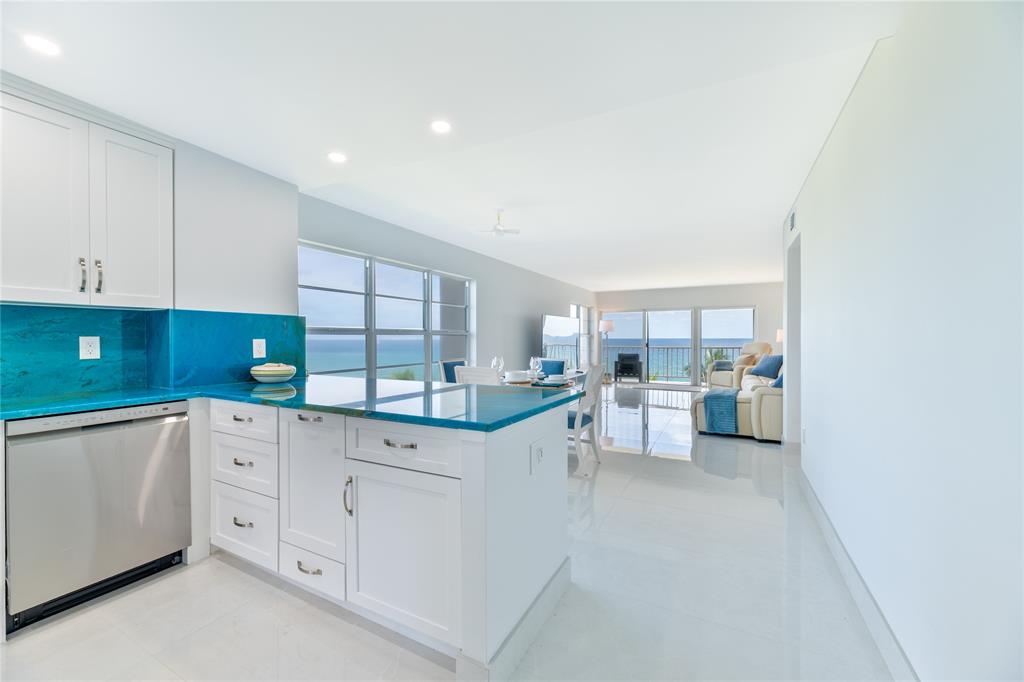 1021 Hillsboro Mile, Unit 308 Hillsboro Beach, FL 33062 - Photo 6 of 24 a kitchen with white cabinets and sink