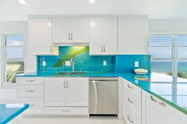 a kitchen with white cabinets and a sink
