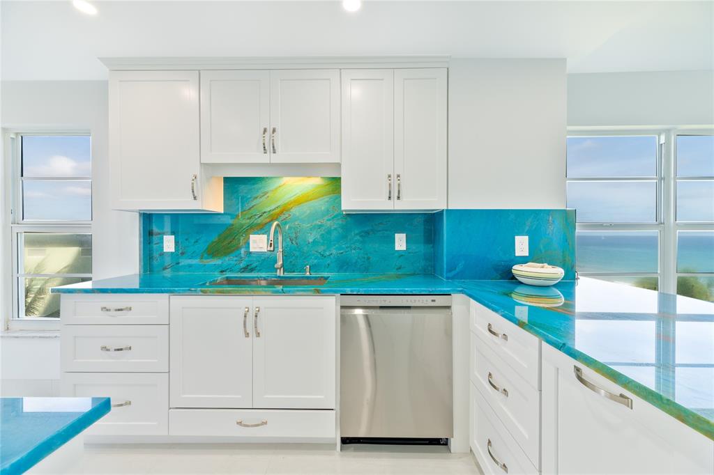 1021 Hillsboro Mile, Unit 308 Hillsboro Beach, FL 33062 - Photo 7 of 24 a kitchen with white cabinets and a sink
