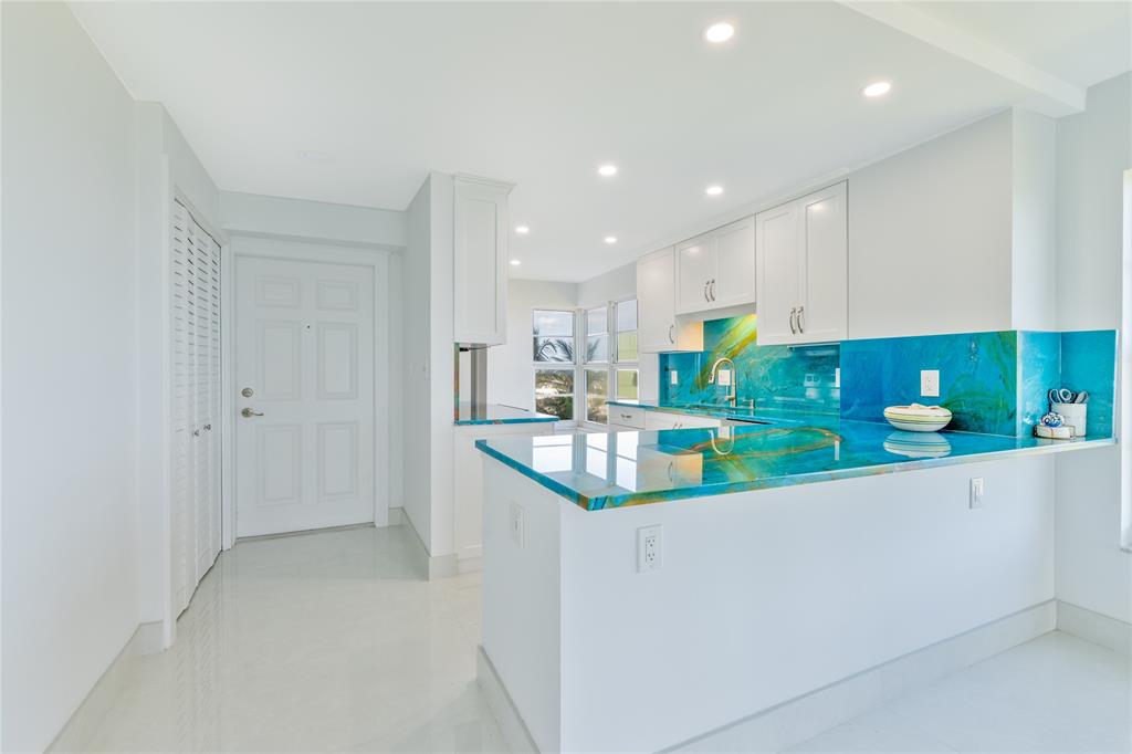 1021 Hillsboro Mile, Unit 308 Hillsboro Beach, FL 33062 - Photo 8 of 24 a kitchen with stainless steel appliances granite countertop a sink and a refrigerator