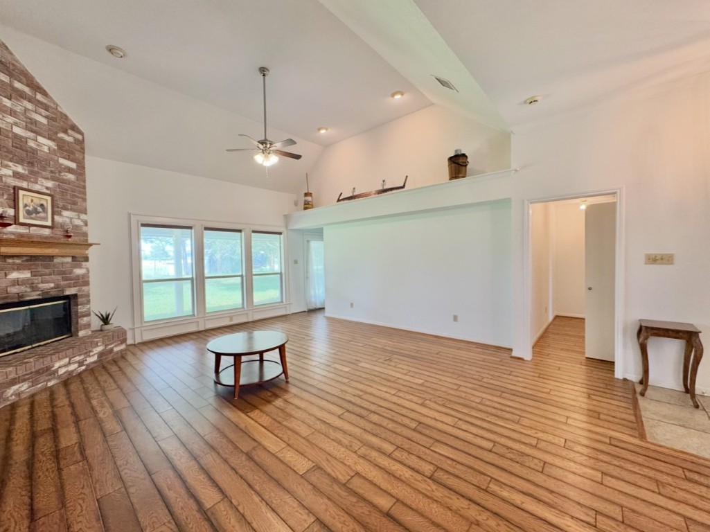 224 Crooked Hollow Road Elgin, TX 78621 - Photo 11 of 35 a view of empty room with wooden floor and windows