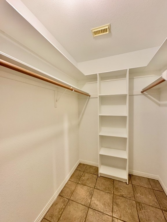224 Crooked Hollow Road Elgin, TX 78621 - Photo 16 of 35 a view of walk in closet with empty racks
