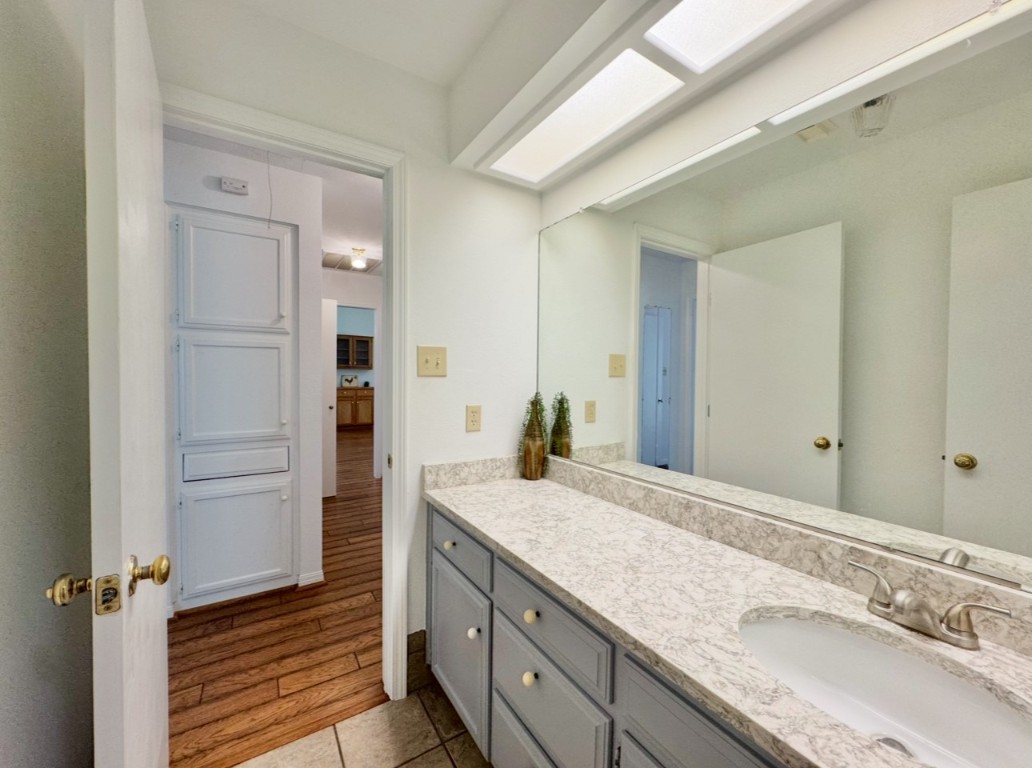 224 Crooked Hollow Road Elgin, TX 78621 - Photo 19 of 35 a bathroom with a granite countertop sink and a mirror
