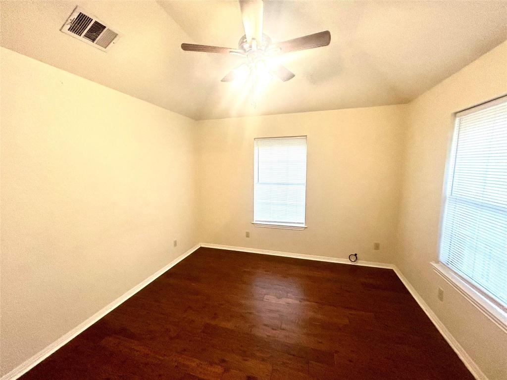 224 Crooked Hollow Road Elgin, TX 78621 - Photo 25 of 35 an empty room with a window and a ceiling fan