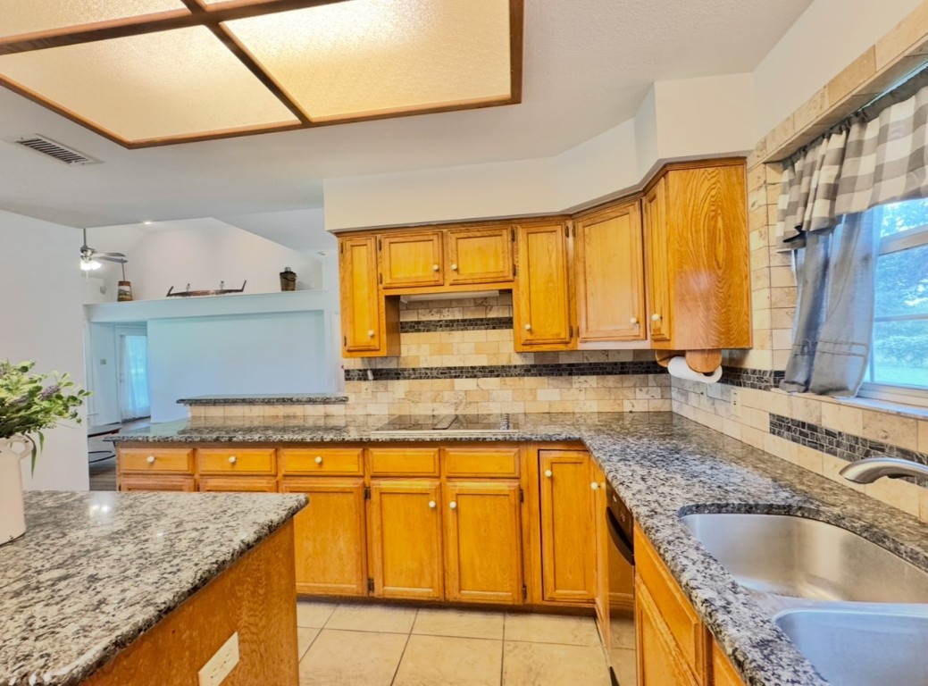 224 Crooked Hollow Road Elgin, TX 78621 - Photo 8 of 35 a kitchen with a sink a counter top space and cabinets