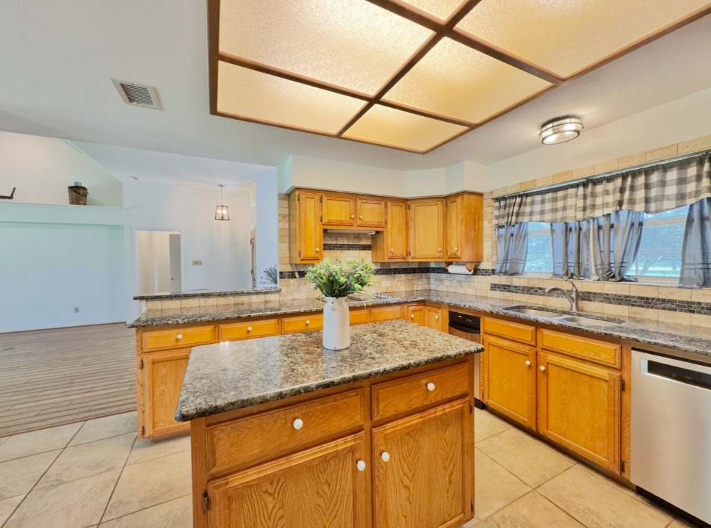 224 Crooked Hollow Road Elgin, TX 78621 - Photo 9 of 35 a kitchen with stainless steel appliances granite countertop a sink and cabinets