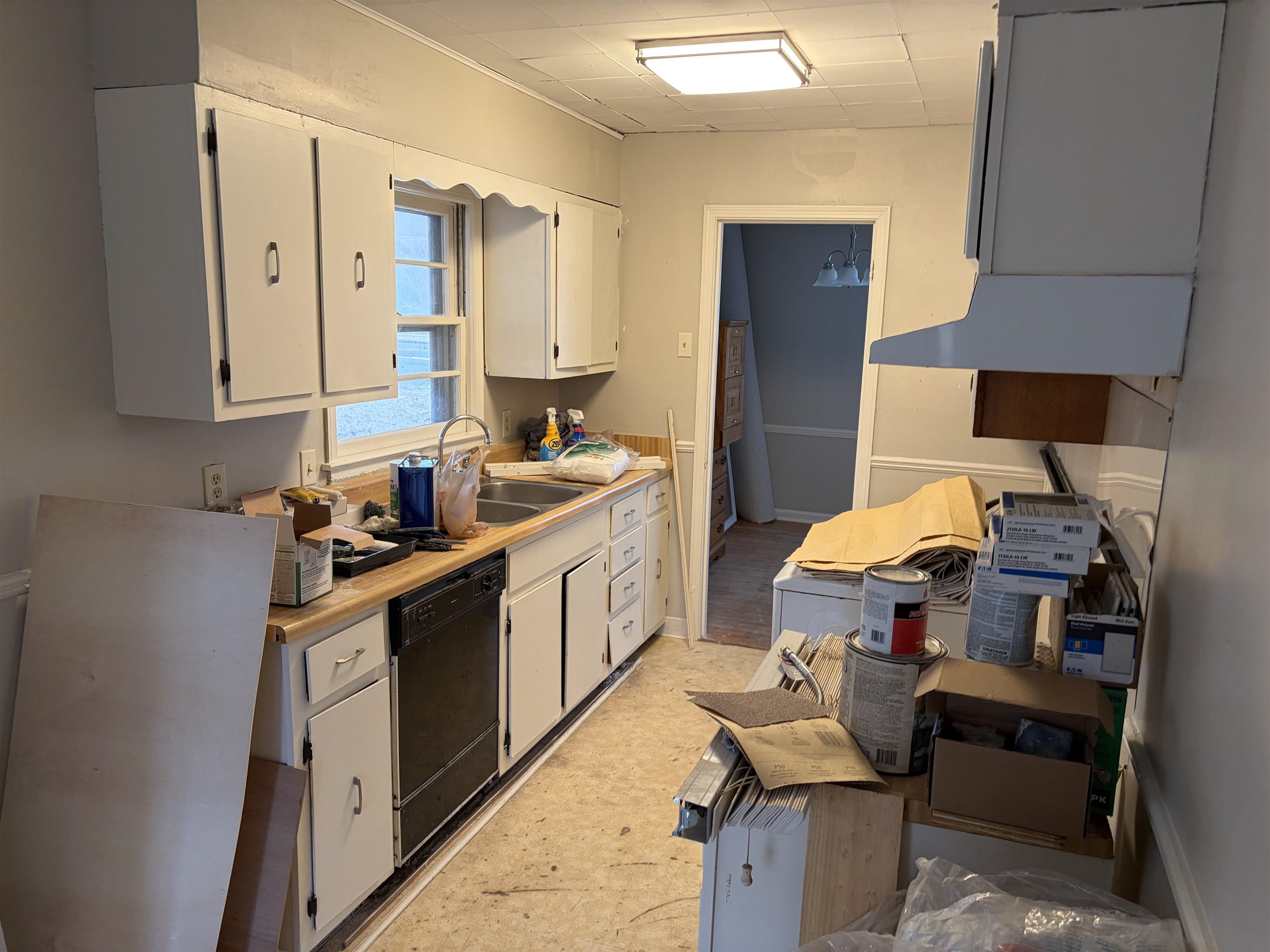 4928 Willow Road Memphis, TN 38117 - Photo 14 of 16 Kitchen featuring light countertops, white cabinets, dishwasher, and a drop ceiling