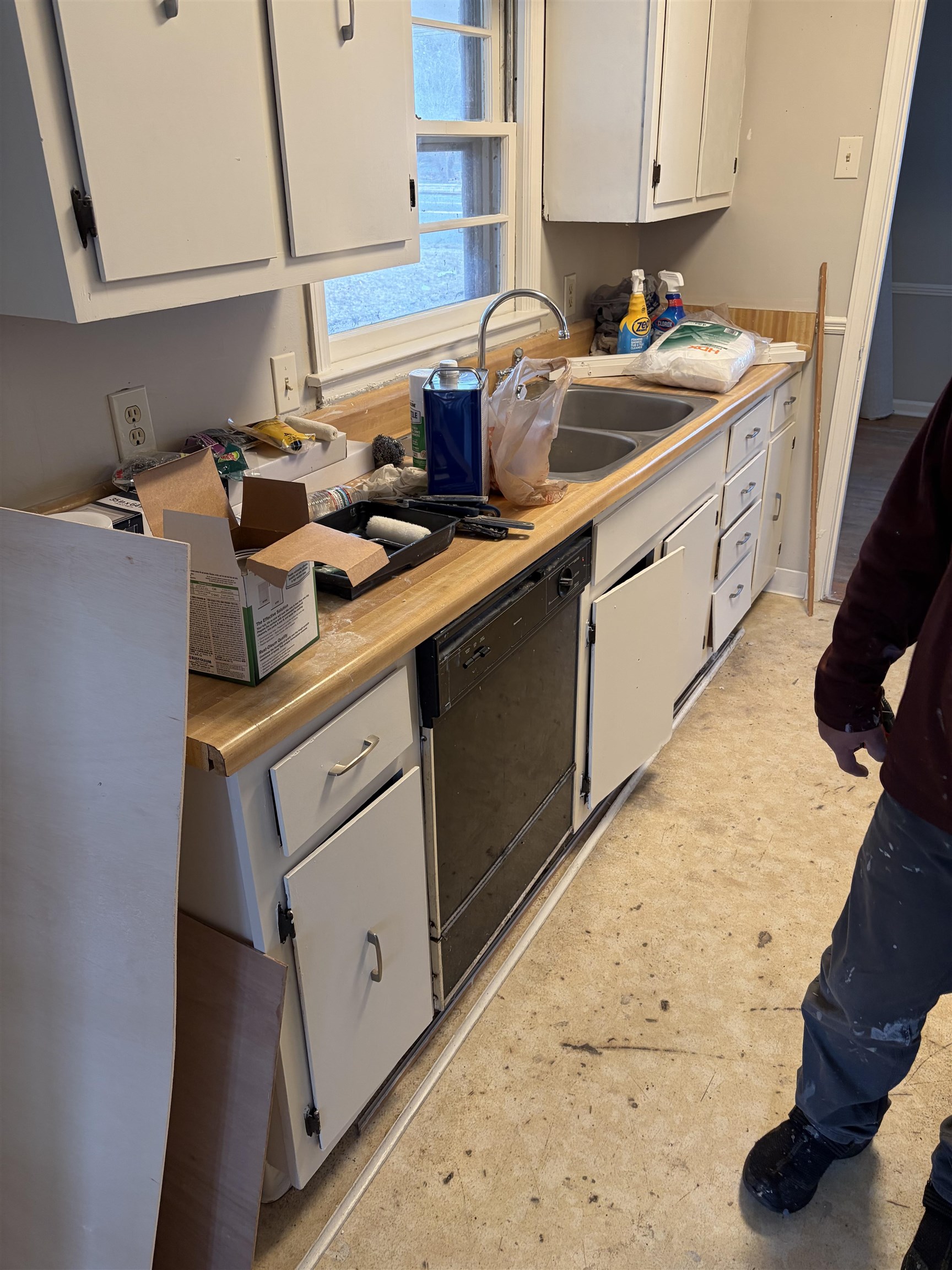 4928 Willow Road Memphis, TN 38117 - Photo 16 of 16 Kitchen featuring light countertops, white cabinets, black dishwasher, and light floors